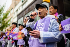In this photo taken on April 5, 2023, Lee Jong-chul (with microphone), whose 24-year-old son Lee Ji-han was killed during a Halloween crowd crush in October last year, attends a rally with other families of victims and supporters near the alleyway where the disaster took place in the popular Itaewon district of Seoul. Families of the Itaewon victims want answers about why authorities failed to prevent the catastrophe despite clear warning signs, with some families forming a group “to understand what really happened and to hold those officials responsible.“ But the internet interpreted their efforts to organise as an attack on the government, with right-wing trolls launching a coordinated counter-attack, accusing the families of being profiteers out for compensation, or anti-government forces.
