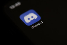 This illustration picture taken on May 27, 2020 in Paris shows the logo of the social network application Discord on the screen of a phone. 
