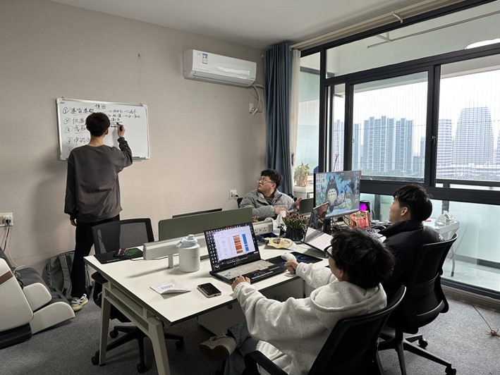 Dongjun Zhao (standing), a student at Xi’an Jiaotong-Liverpool University (XJTLU) Entrepreneur College (Taicang) and members of his successful e-commerce business at work. 