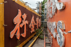 This picture taken on March 21, 2023 shows removed neon signboards being placed at a storage place of Tetra Neon Exchange (TNX) - a neon heritage group - in the northwest of Hong Kong.