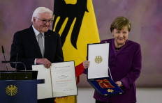 German President Frank-Walter Steinmeier (L) awards the Order of Merit to former German Chancellor Angela Merkel at the Bellevue presidential palace in Berlin on April 17, 2023.