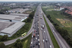 This aerial picture shows thousands of vehicles are stuck in long traffic jams on the freeway heading out of Jakarta, in East Karawang, on April 28, 2022, while heading to their hometowns to celebrate the long Idul Fitri holiday with their families. 
