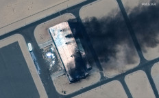 This handout satellite image courtesy of Maxar Technologies taken on April 18 shows a burning building at the Merowe Airport in Sudan. A weeks-long power struggle erupted into deadly violence on April 15 between the forces of two generals who seized power in a 2021 coup.