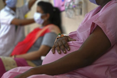Pregnant women wait for their turn to get inoculated with dose of the Covaxine vaccine against COVID-19 at a government maternity and child hospital in Chennai, India, on July 5, 2021. 