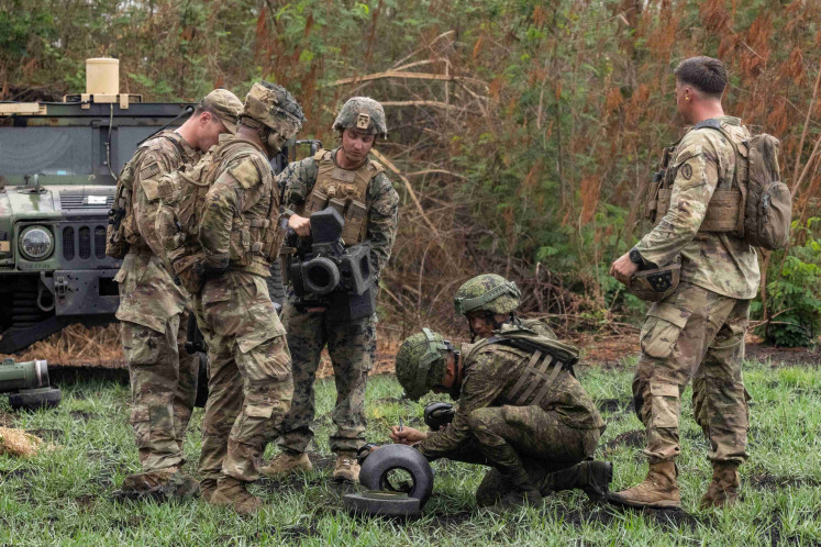 A Filipino soldier signs his name on a Javelin missile case after firing the anti-tank weapon for the first time during a live fire exercise in the annual US-Philippines joint military exercises called 