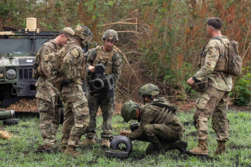 A Filipino soldier signs his name on a Javelin missile case after firing the anti-tank weapon for the first time during a live fire exercise in the annual US-Philippines joint military exercises called 
