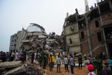 In this file photo taken on April 26, 2013 Bangladeshi volunteers and rescue workers conduct rescue operations 60 hours after the Rana Plaza garment building collapsed in Savar, on the outskirts of Dhaka.