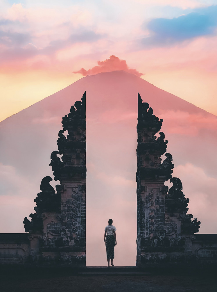 Serenity: Sunrise over a mountain is viewed from a Balinese temple (Pexels/Stijn Dijkstra)