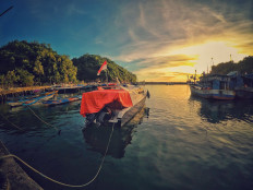 Still waters: Boats are berthed in an Indonesian port (Pexels/Ahmad Syahrir)