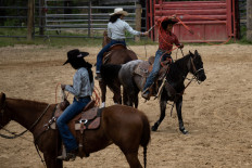 Reagan Jackson, Morissa Hall, and Ryan Jackson practice calf roping at the Jackson family's ranch in Upper Marlboro, Maryland, on April 15, 2023. Guiding her brown mare around the arena at breakneck speed, 16-year-old Morissa Hall is extremely focused as she attacks the barrel racing course in the eastern US state of Maryland. Tempestt Martin, who grew up nearby in Washington, says she also faced suspicious glances in her early days competing in local rodeo events.
She, along with three childhood friends, established the Black cowgirl group “Catch this Smoke,“ a phrase often used to warn others off.
