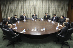 Bank of Japan Governor Kazuo Ueda (top center) attends a monetary policy meeting at the BOJ headquarters in Tokyo on April 28, 2023.