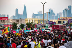 In this file photo taken on November 18, 2022 People walk towards Souq Waqif marketplace in Doha ahead of the Qatar 2022 World Cup football tournament. Months after hundreds of thousands of football fans packed into its hotels and stadiums, Qatar is seeking to remedy a bout of the post-World Cup blues by hosting more international events. Along with the departed football crowds, thousands of foreign workers left the Gulf state after Lionel Messi lifted the coveted trophy on December 18. Many of those who stayed on are counting the cost.
