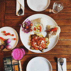 Home-cooked: The Tannoor's baynjan borani, pan-fried eggplant with tomato gravy sauce and onion topped with yoghurt and mint, is served with zeera rice and Afghani naan. (Courtesy of The Tannoor)