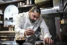 Lebanese Michelin-Starred chef Alan Geaam prepares a dish in his restaurant 'Alan Geaam', in Paris on December 22, 2022. My mum doesn't agree with what I'm doing here: back home, we don't eat like this,“ laughs Alan Geaam, the first and only starred Lebanese chef in his gastronomic restaurant in Paris.