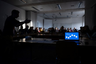 High school English and philosophy teacher Eric Vanoncini (left) is seen in silhouette heading a workshop on ChatGpt organized for teachers by the School Media Service (SEM) of the Public education of the Swiss canton of Geneva on Feb. 1, 2023.
