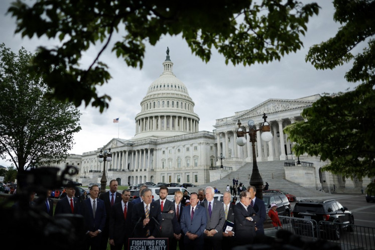 A group of Senate Republicans hold a news conference to urge the White House and Senate Democrats to pass the House GOP legislation that would raise the debt limit and cut federal spending outside the US Capitol in Washington, DC, on May 03, 2023.