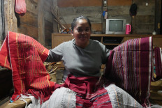 Creator: Uli Artha Panggabean shows some of the 'ulos' she has made. (JP/Tonggo Simangunsong)