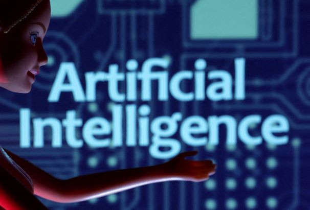 A figurine is placed in front of a sign reading "Artificial Intelligence" in this illustration taken on March 31, 2023. 