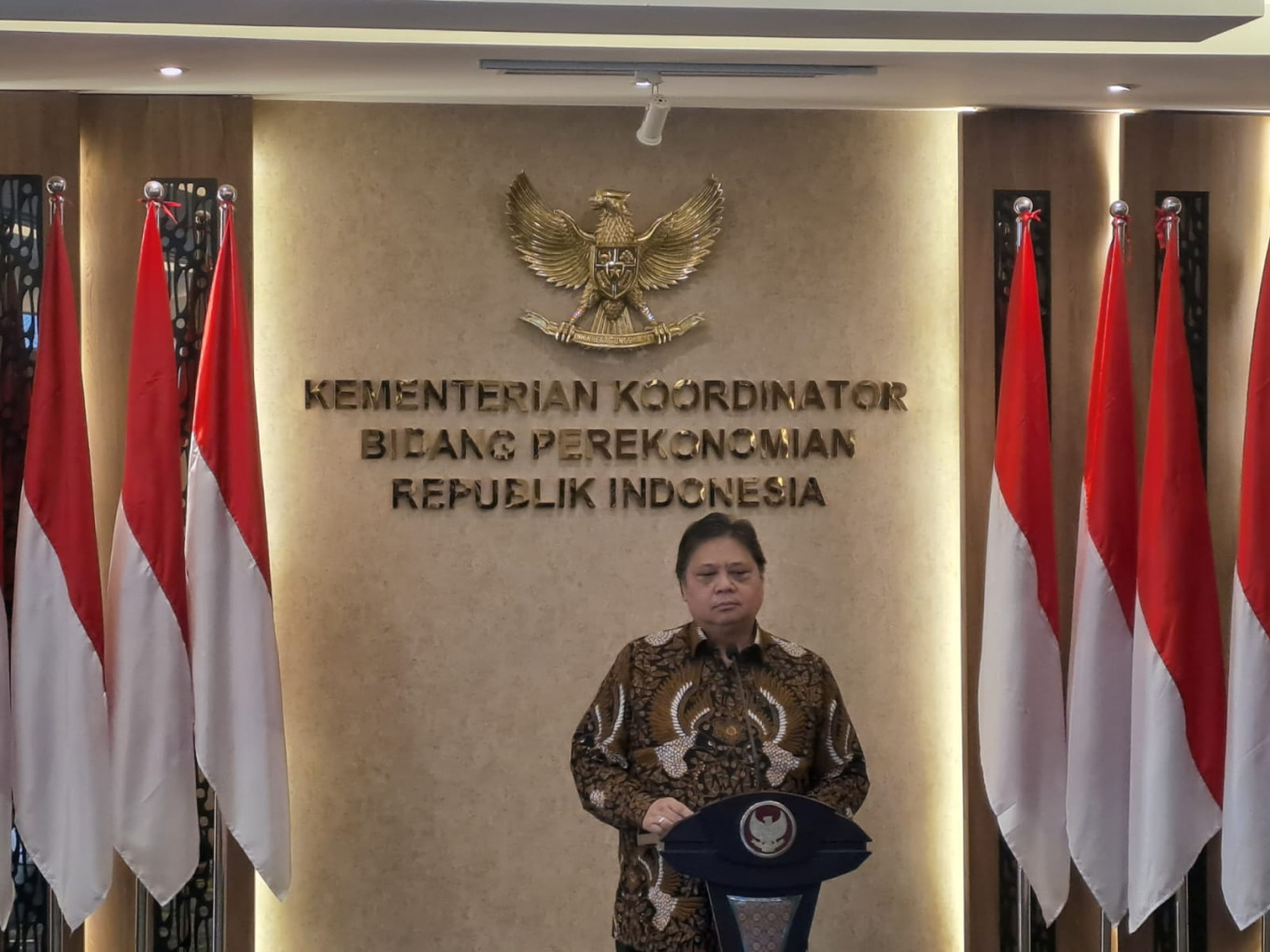 Coordinating Economic Minister Airlangga Hartarto stands on the podium, looking at the materials he is about to present on May 5, 2023.