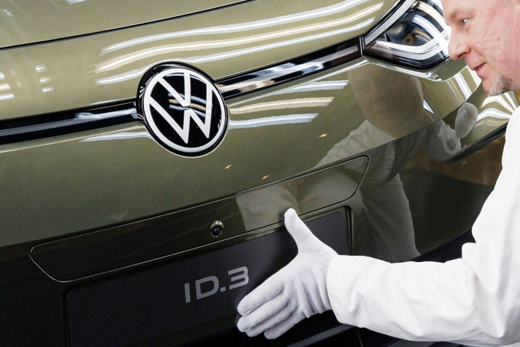 A VW employee presents the new model of the electric Volkswagen ID 3 car of German carmaker Volkswagen at the Transparent Factory (Glaeserne Manufacturer) production site in Dresden, eastern Germany on March 1, 2023. 