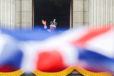 Britain's King Charles waves as he stands on the Buckingham Palace balcony following the coronation ceremony in London, Britain, May 6, 2023. 