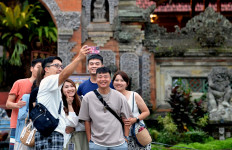 People take photographs in Ubud, a famous tourist destination in Gianyar regency, Bali, on May 6. 