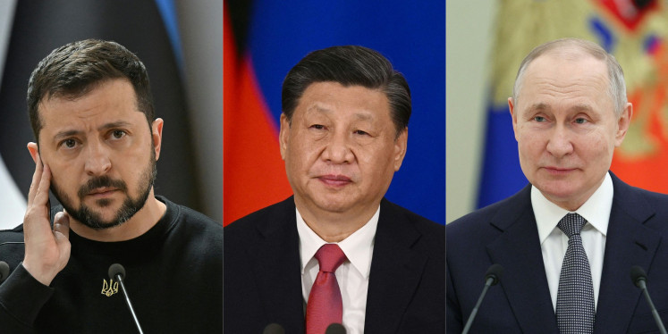 This combination of pictures created on April 26, 2023 shows Ukrainian President Volodymyr Zelensky (left) listening during a joint press conference, China's President Xi Jinping (center) attending a signing ceremony at the Kremlin in Moscow, Russia, and Russian President Vladimir Putin (right) giving a speech during a separate ceremony at the Kremlin.
