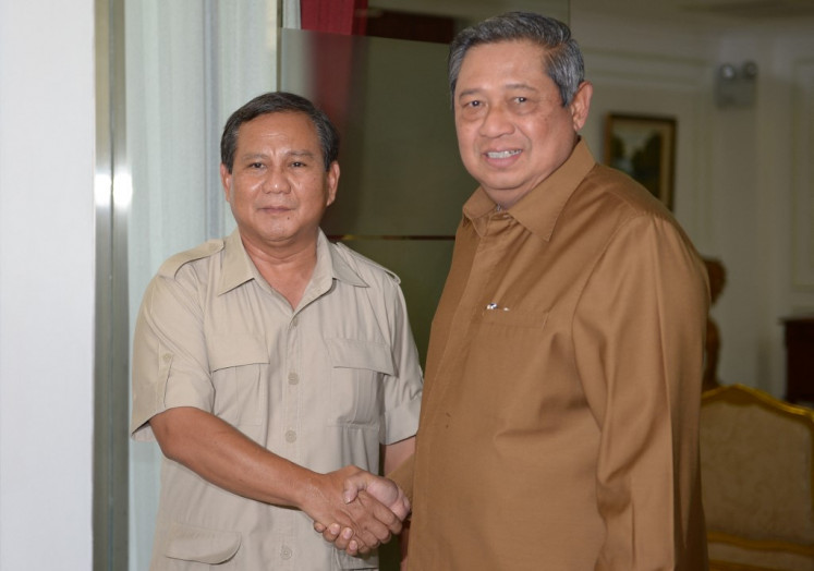 Former president Susilo Bambang Yudhoyono (right) shakes hand with defense minister and chairman of the Gerindra Party Prabowo Subianto (left) before a meeting at the presidential palace in Jakarta on March 11, 2013, ahead of the 2012 presidential elections. 