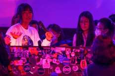 This photo taken on March 5, 2023 shows Eloise Fan, co-founder of an electronic music label called “Scandal“ which features women producers from around China, teaching DJ skills at a club in Shanghai. Tired of Shanghai club nights dominated by men, where a woman's appearance often matters as much as her musical skills, Eloise Fan has created an underground space where women DJs are free to shine.
