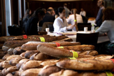 A photograph taken on May 10, 2023 shows baguettes in front of members of the jury during the annual “Grand prix de la baguette de tradition française de la Ville de Paris, aka the best baguette in Paris competition, in Paris.