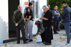 Voters wait in a queue to vote at a polling station during the presidential and parliamentary elections, in Hatay, Turkey May 14, 2023. 