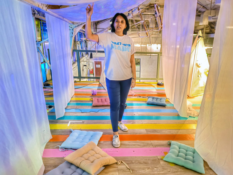 For the children: Elisabeth Tita showing a makeshift children's tent that they made for the festival in MBloc Space, on Apr 28. (JP/Sylviana Hamdani)