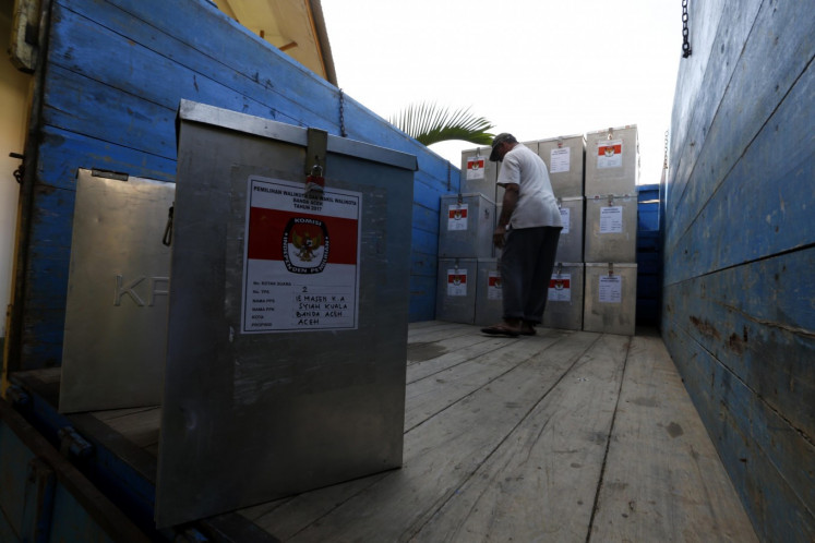 Workers are loading ballot boxes onto trucks before being distributed to polling stations in various regions in Aceh 14 February 2017. 