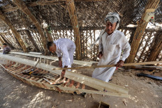 In this picture taken on April 29, 2023, a carpenter hammers beams as he builds a traditional &ldquo;meshhouf&ldquo; wooden boat at a workshop in the area of al-Huwair in the sub-district of al-Madinah in Iraq's southern Basra province. A flotilla of traditional wooden boats piloted by young Iraqis makes its way along Baghdad's Tigris river, revealing a glimpse of the now drought-stricken country's ancient waterborne heritage. Once a fixture on Iraq's rivers and marshes, the elongated boats with tapered ends, known as &ldquo;meshhouf&ldquo;, have been present &ldquo;since the time of the Sumerians&ldquo;, says organiser Rashad Salim -- but their continued existence is threatened by modern technology and the impacts of climate change.
