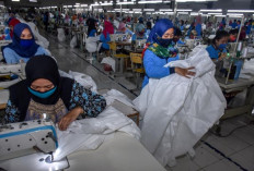 Lifesavers: Female workers produce waterproof personal protective equipment (PPE) on April 20, 2020 at a factory in Malang, East Java. The factory switched from producing garments to PPEs in response to rising demand during the COVID-19 pandemic.