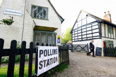 A man walks near The Brocket Arms pub which is acting as a polling station for local elections in Ayot St Lawrence, Britain, May 4, 2023. 