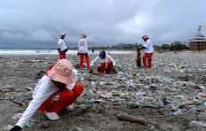 Volunteers collect plastic waste during a beach cleanup activity on April 13 at Kuta Beach in Badung regency, Bali. 