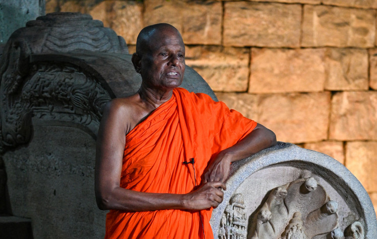 Monk Pallegama Hemarathana, chief custodian of the ancient Bodhi tree, on May 19, 2023, speaks during an interview with AFP at the Sri Maha Bodhi temple in Anuradhapura.