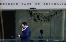 A man walks past the Reserve Bank of Australia in the central business district of Sydney on June 7, 2022.