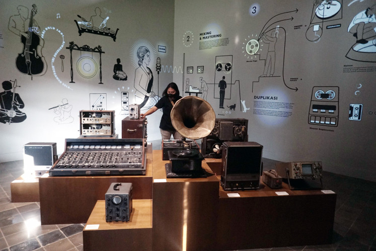 A visitor on June 2 looks at old music equipment on display, including a phonograph, at the Lokananta Museum in Surakarta, Central Java, on June 2, 2023.