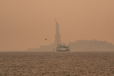 A smoky haze from wildfires in Canada envelops the Statue of Liberty in Upper Bay on June 7, 2023 in New York City. New York topped the list of most polluted major cities in the world on Tuesday night, as smoke from the fires continues to blanket the East Coast.  
