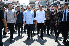 Malaysia's Prime Minister Anwar Ibrahim (left) and President Joko “Jokowi“ Widodo (right) arrive at the Samudra Patin Restaurant in Kuala Lumpur on June 8, 2023. 
