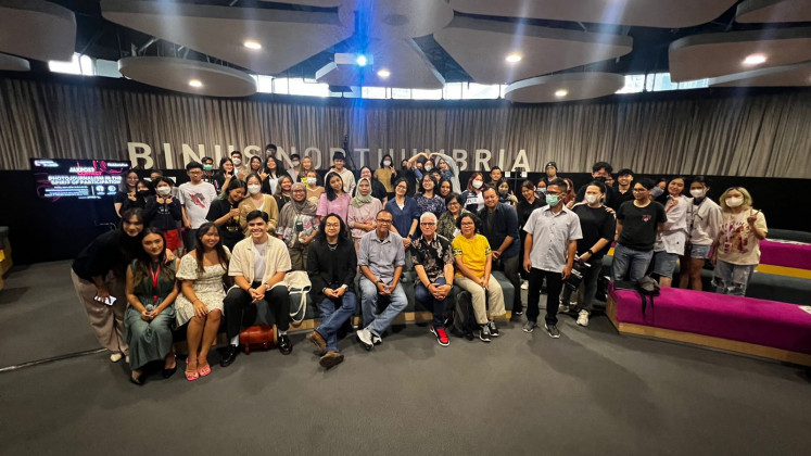 The audience poses with speakers following the talk Photojournalism in the Spirit of Participation at Binus International FX Sudirman Campus in Jakarta on Tuesday.