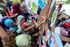 Children make a tree out of paper cutouts during an event held by the University of Indonesia in Depok, West Java, on June, 8, 2023. The event featuring storytelling and drawing was part of this year’s World Environment Day commemorations at the university.