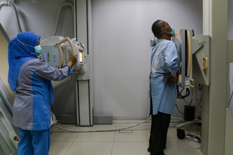 Early detection is key: A health worker (left) takes a chest X-ray of a patient on March 21, 2023, at Tangerang City General Regional Hospital in Banten.
