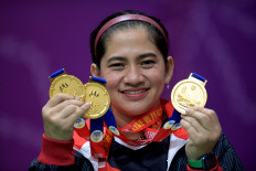 Indonesian para-badminton athlete Leani Ratri Oktila shows off the gold medals she won at the 2023 ASEAN Para Games on June 9, 2023, during an awarding ceremony at Morodoc Techo Badminton Hall in Phnom Penh, Cambodia. Indonesia became overall winner of the Para Games in badminton with 13 gold, nine silver and eight bronze medals.