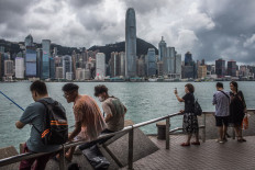 People visit a promenade next to Victoria Harbour in Hong Kong, China, on June 8, 2023.