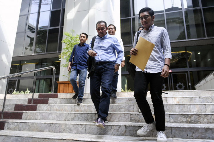 Indonesia Corruption Watch researcher Kurnia Ramadhana (right) leaves the Constitutional Court in Jakarta on June 12, 2023. The ICW is a member of the Civil Society for Clean Elections, which is seeking to overturn a 2023 regulation that allows ex-graft convicts to run for public office again less than five years after they first completed their prison term.