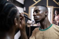 Djibril Gueye, also known as Djibou, the most popular Central African make up artist, work with a customer in his beauty salon in Bangui, on January 28, 2023.
