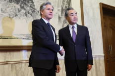 US Secretary of State Antony Blinken (left) shakes hands with China's Director of the Office of the Central Foreign Affairs Commission Wang Yi at the Diaoyutai State Guesthouse in Beijing on June 19, 2023. 
